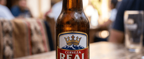 Bottle of Cerveza Real Bolivian pilsener beer on a wooden surface