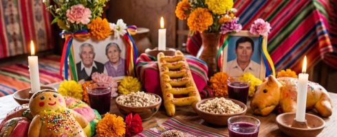 Day of the Dead altar with flowers, candles, photographs, and traditional food offerings