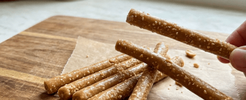 Peanut and caramel cylindrical snack sticks with packaging labeled Chamuna's